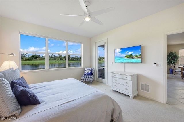 bedroom featuring light carpet, a ceiling fan, baseboards, visible vents, and access to exterior