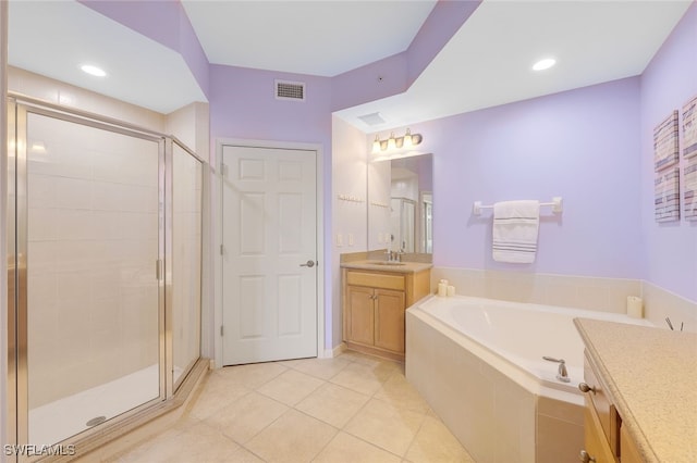 full bath featuring a garden tub, vanity, visible vents, a shower stall, and tile patterned floors