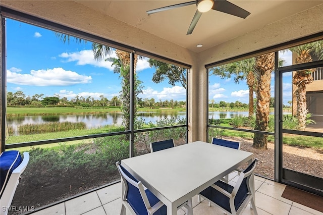 sunroom / solarium featuring a water view and ceiling fan