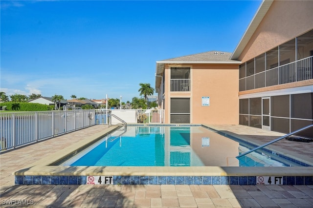 view of swimming pool with a patio area