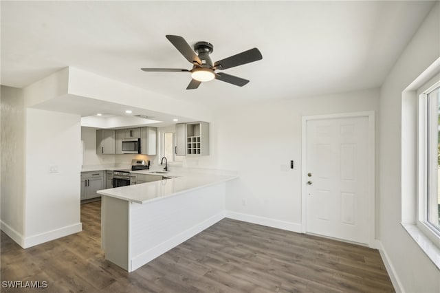 kitchen with ceiling fan, dark hardwood / wood-style floors, gray cabinets, and appliances with stainless steel finishes