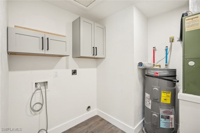 clothes washing area featuring cabinets, water heater, washer hookup, dark hardwood / wood-style flooring, and hookup for an electric dryer