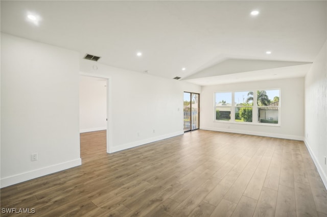 unfurnished living room with lofted ceiling and wood-type flooring