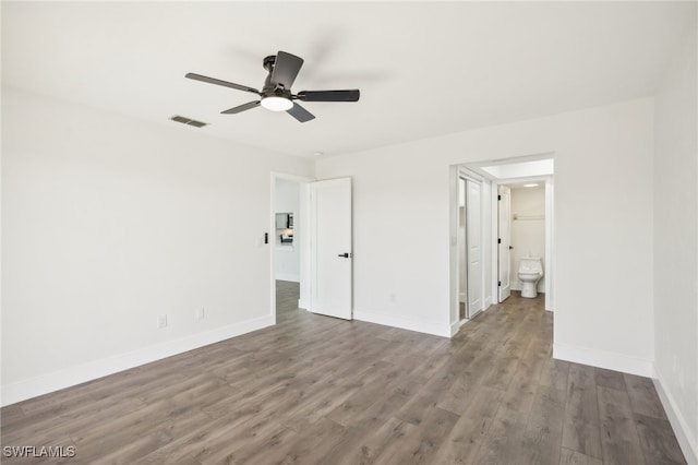 unfurnished bedroom featuring ensuite bath, wood-type flooring, and ceiling fan