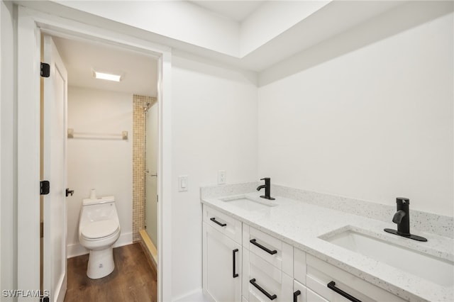 bathroom with walk in shower, toilet, wood-type flooring, and vanity