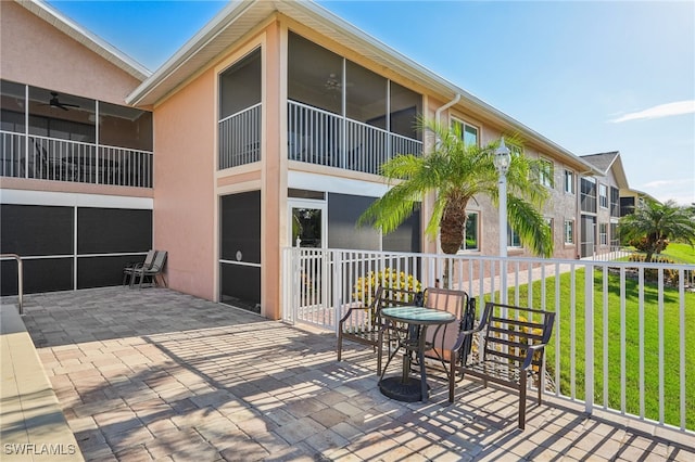 exterior space featuring a yard, ceiling fan, and a patio area