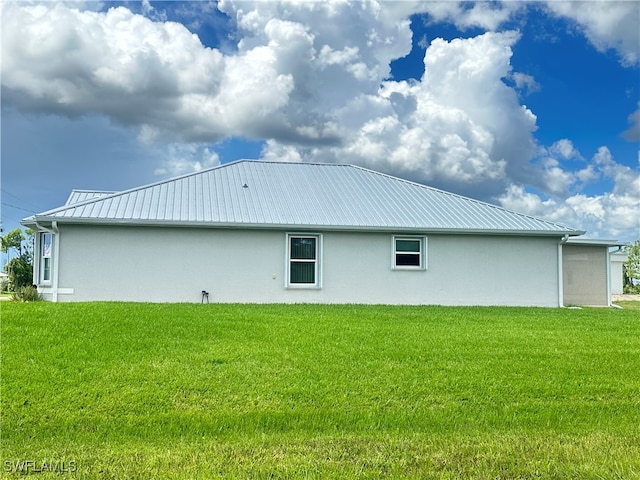 rear view of property with a lawn