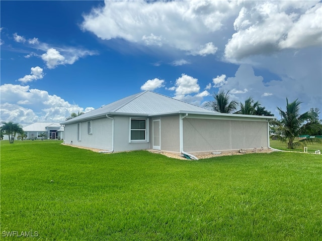 rear view of property with a lawn