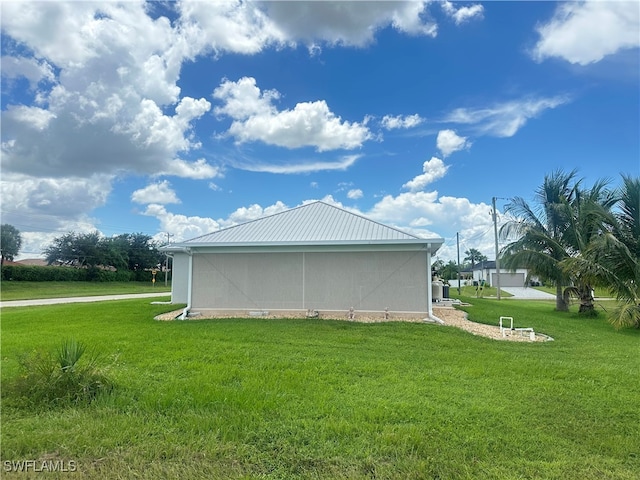 view of side of property with a yard