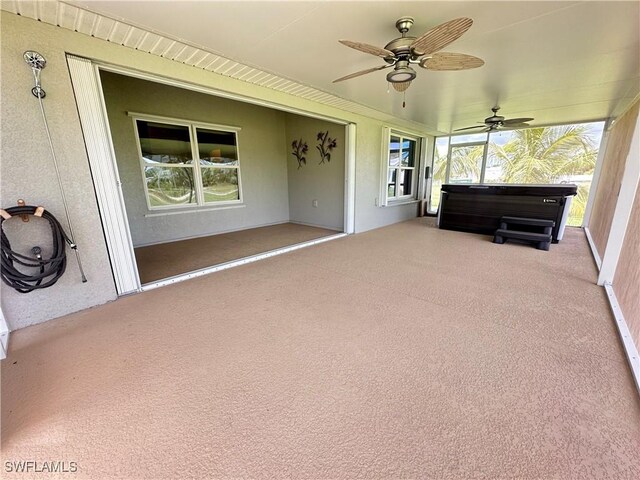 unfurnished sunroom with a wealth of natural light and ceiling fan