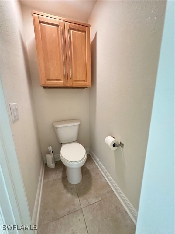 bathroom featuring toilet and tile patterned floors