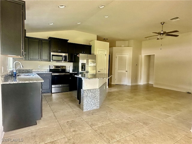 kitchen featuring a kitchen island, vaulted ceiling, appliances with stainless steel finishes, sink, and ceiling fan