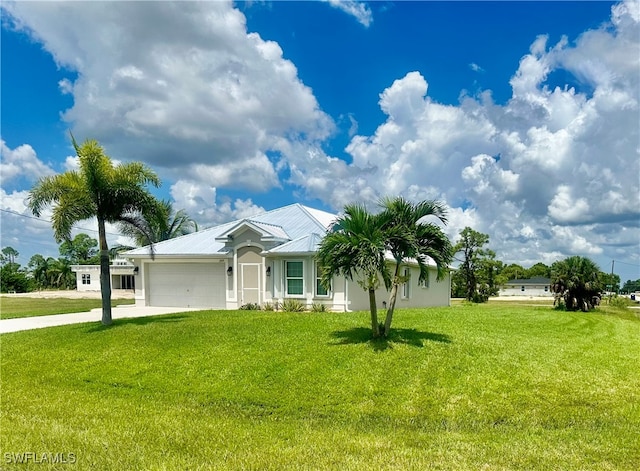 ranch-style house featuring a front yard and a garage