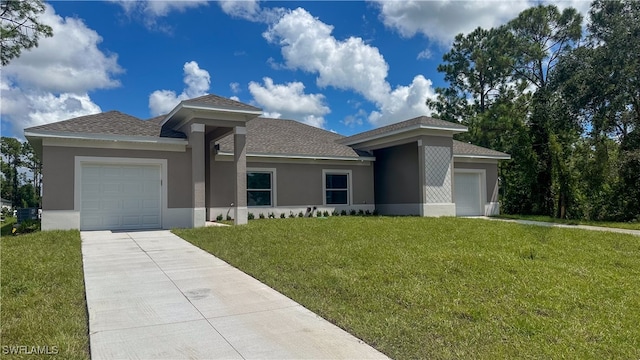 view of front of property featuring a front yard and a garage