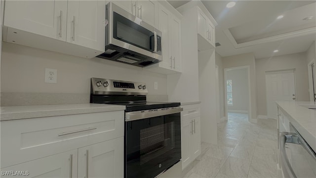 kitchen featuring appliances with stainless steel finishes and white cabinets