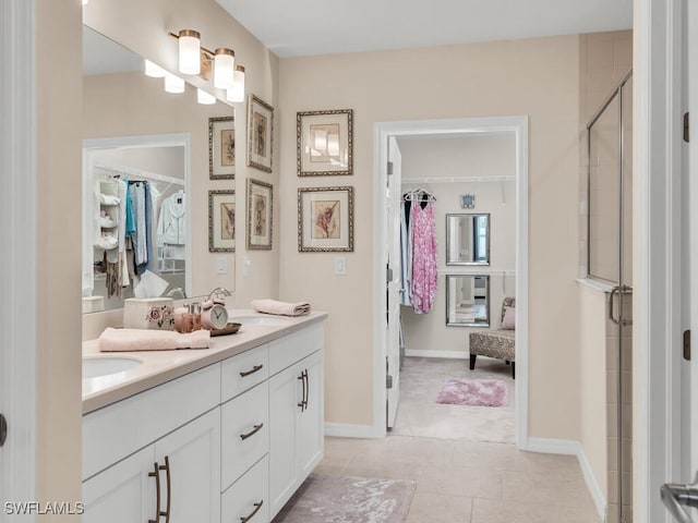 bathroom featuring tile patterned floors, vanity, and walk in shower