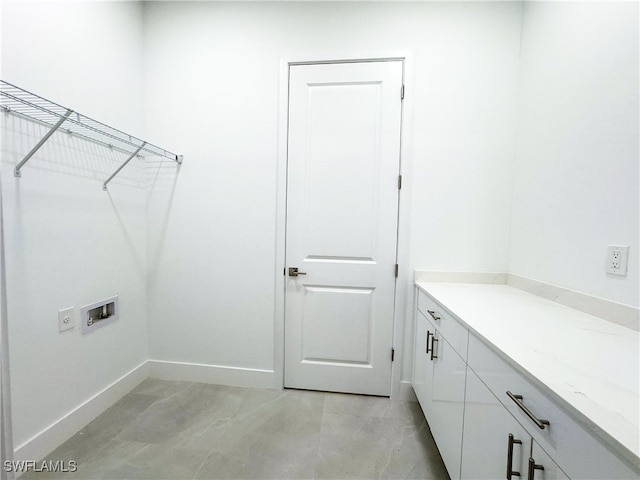 laundry area featuring washer hookup and cabinets