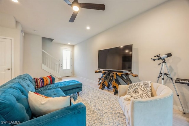 living area featuring stairway, recessed lighting, a ceiling fan, and baseboards