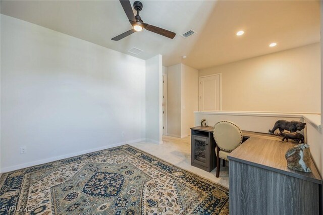 office space with a ceiling fan, baseboards, visible vents, recessed lighting, and light carpet