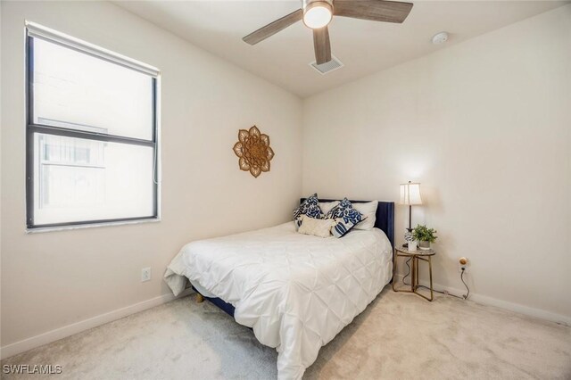 bedroom with visible vents, carpet floors, baseboards, and a ceiling fan