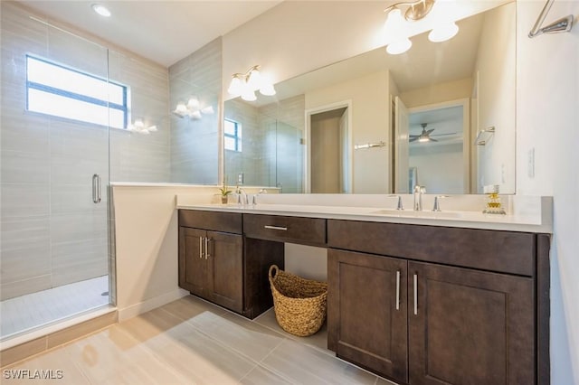 bathroom with a sink, a stall shower, double vanity, and tile patterned flooring