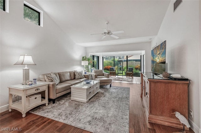 living room with wood finished floors, a ceiling fan, visible vents, and baseboards