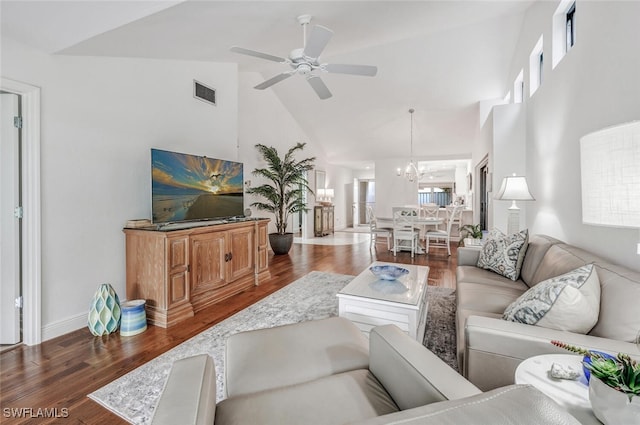 living room featuring visible vents, baseboards, ceiling fan with notable chandelier, wood finished floors, and high vaulted ceiling