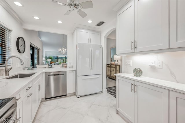 kitchen with visible vents, a sink, white cabinets, appliances with stainless steel finishes, and ceiling fan with notable chandelier