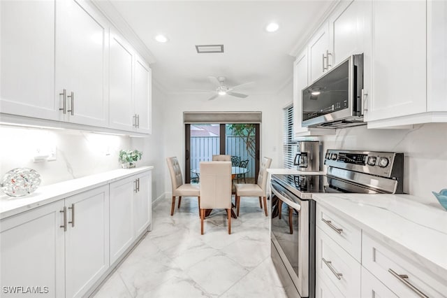 kitchen with white cabinetry, visible vents, marble finish floor, and stainless steel appliances