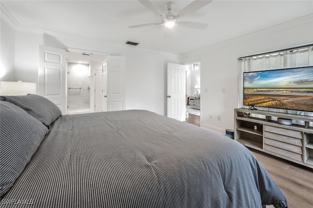 bedroom with visible vents, wood finished floors, connected bathroom, crown molding, and ceiling fan