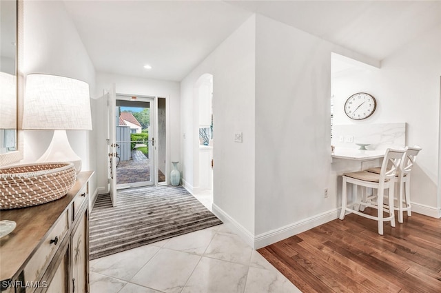 entryway featuring recessed lighting, baseboards, and wood finished floors