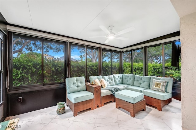 sunroom / solarium featuring a ceiling fan