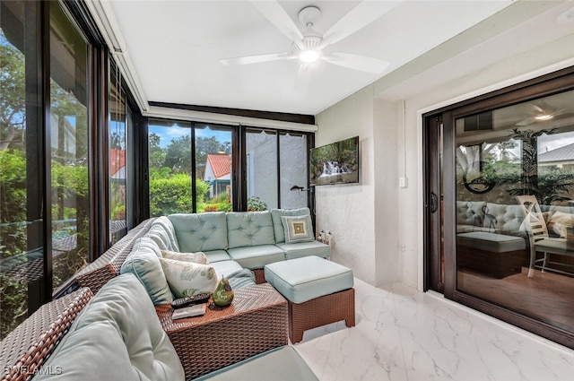 sunroom / solarium with a ceiling fan