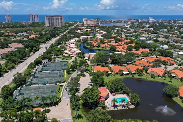 birds eye view of property with a city view and a water view