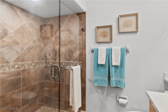 bathroom with vanity and a shower with shower door