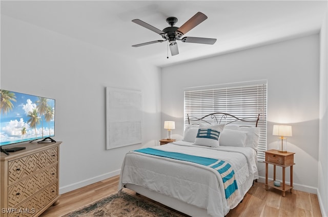 bedroom with light hardwood / wood-style flooring and ceiling fan