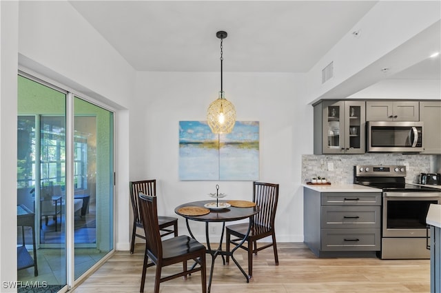 dining space with light hardwood / wood-style floors