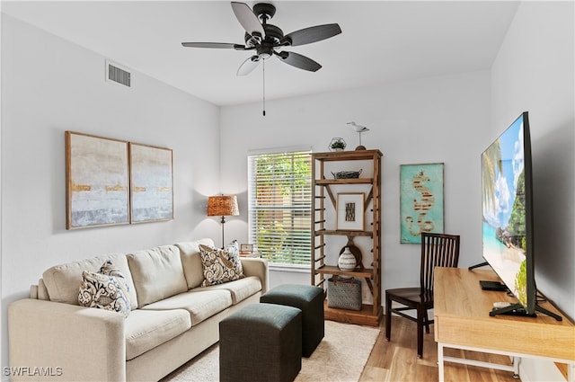 living room with ceiling fan and light wood-type flooring