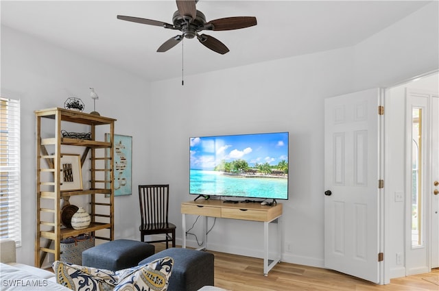 sitting room featuring ceiling fan, light hardwood / wood-style floors, and a healthy amount of sunlight