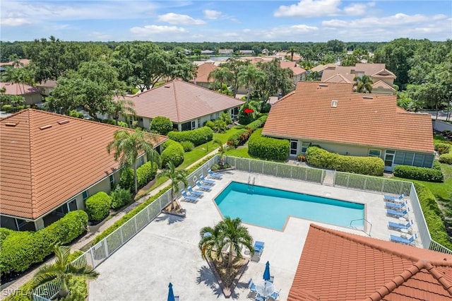 community pool featuring a patio area and fence