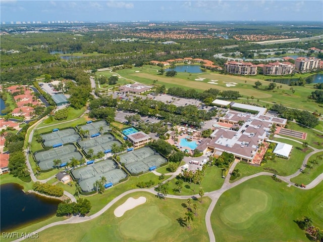 drone / aerial view featuring view of golf course and a water view