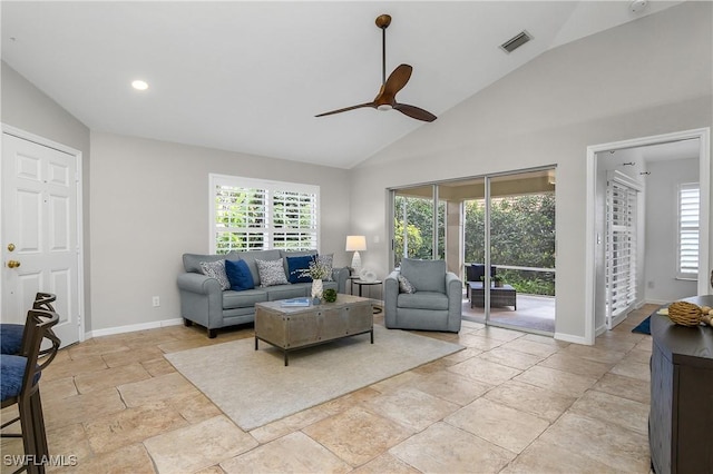 living room with visible vents, plenty of natural light, baseboards, and ceiling fan