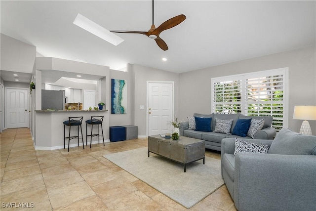 living area featuring vaulted ceiling, baseboards, a ceiling fan, and recessed lighting