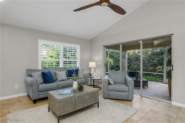 living room featuring a ceiling fan, lofted ceiling, and baseboards