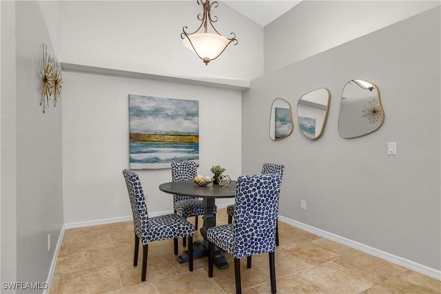 dining space with stone finish floor and baseboards