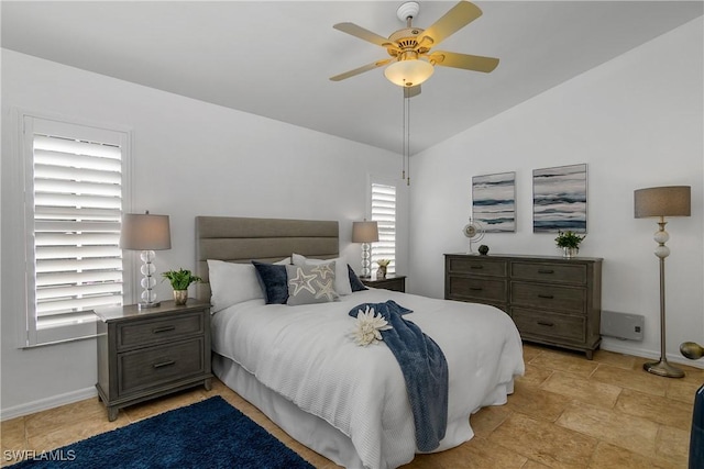 bedroom featuring lofted ceiling, ceiling fan, and baseboards