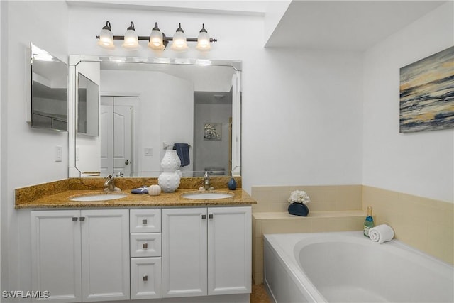 full bathroom featuring double vanity, a garden tub, and a sink