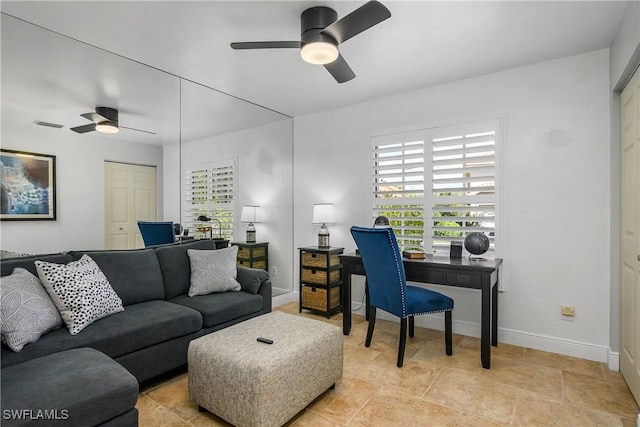 home office featuring ceiling fan and baseboards