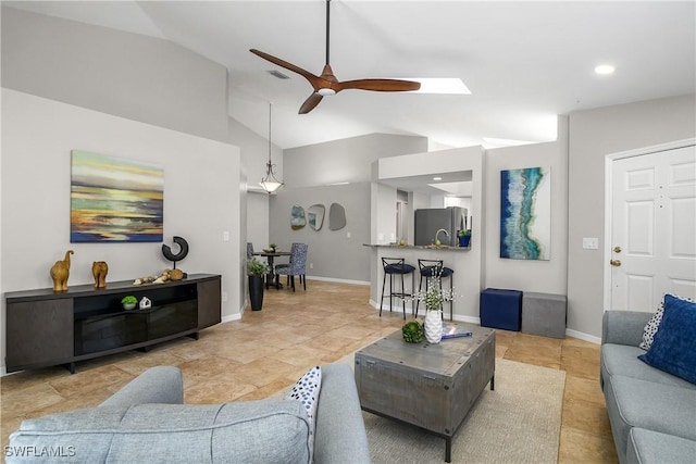 living area featuring vaulted ceiling, visible vents, a ceiling fan, and baseboards