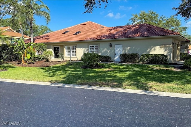 221 Napa Ridge Rd E, Naples, FL 34119 - view of front of house with stucco siding, a tiled roof, and a front lawn
